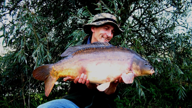 Beautiful 21.4lb mirror taken on a popup over thick silk weed
