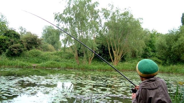 Barrett in action trying to keep a tench out of the lilies on light float tackle